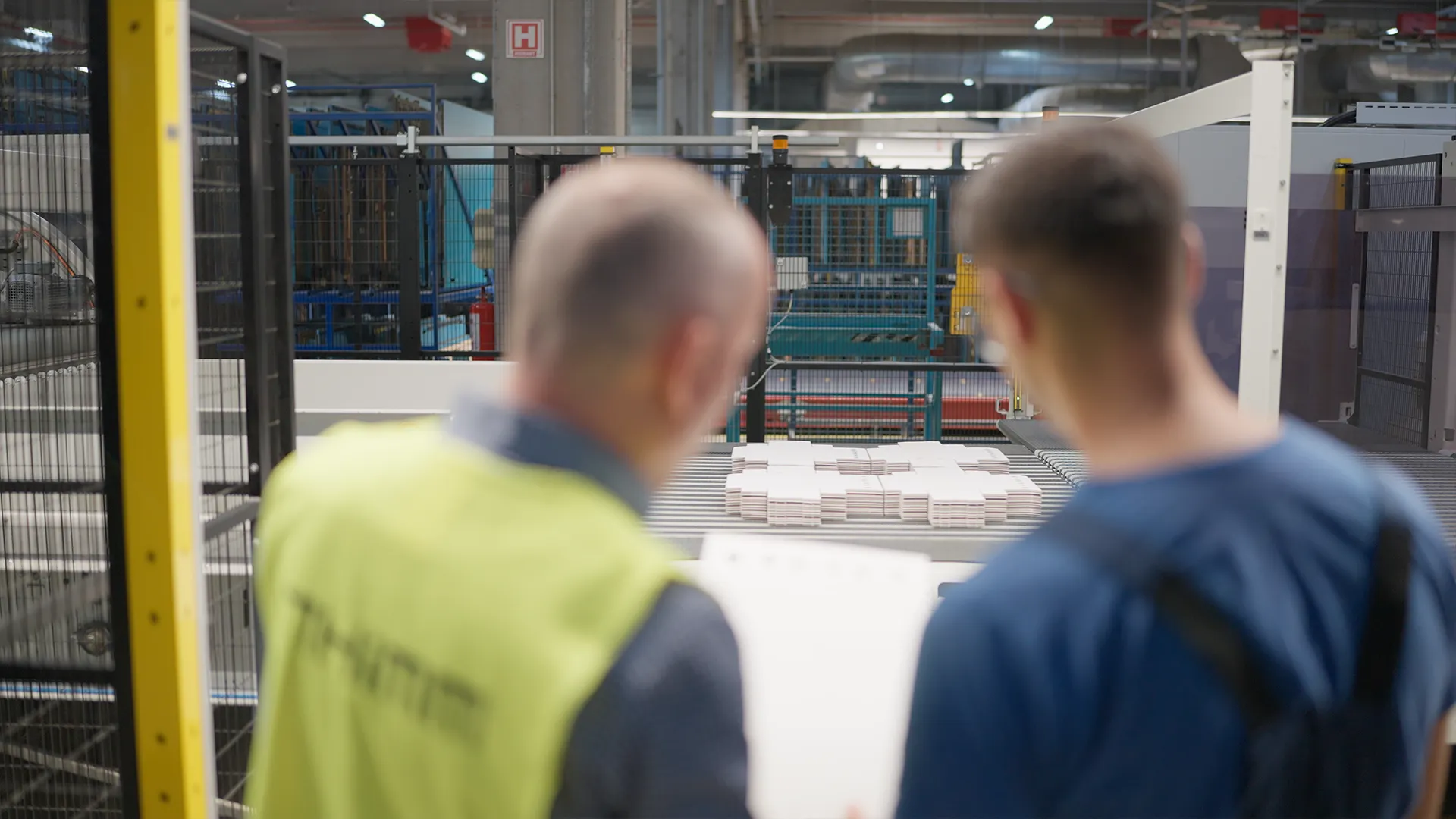 Checking die-cut blanks leaving the BOBST line, shot over the operators' shoulders